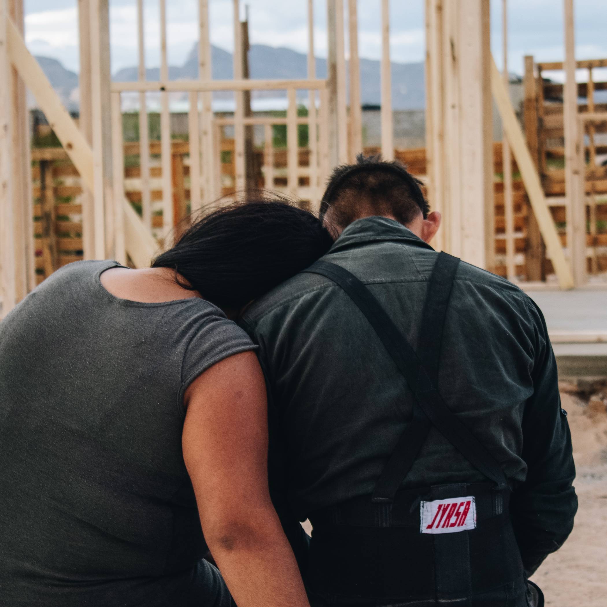 Couple Overlooking Home Being Built